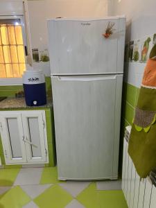 a refrigerator in a kitchen with green and white floors at Étage de villa Elkala in El Kala
