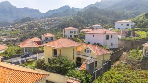 eine Gruppe von Häusern auf einem Hügel mit Bergen im Hintergrund in der Unterkunft Casa Golino by YOUR KEY in São Vicente