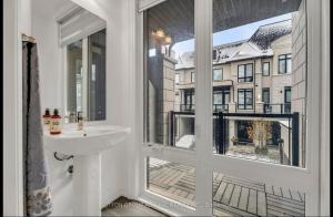a bathroom with a sink and a window with a view at Entire place in Richmond hill Modern Luxury Home in Richmond Hill +28 photos