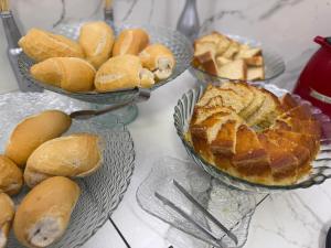 a table topped with plates of bread and pies at On Park Hotel e Traslado in Guarulhos