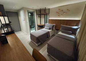 a hotel room with two beds and a room with birds on the wall at Nord Class Rio 83 in João Pessoa +17 photos