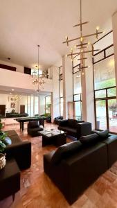 a large living room with couches and a pool table at Incredible Loft with pool in Chuburná de Hidalgo