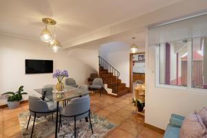 un soggiorno con tavolo e sedie in vetro di Casa Jardim Celeste a Seixal