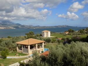 a villa with a view of the water at Kolona Apartments in Lixouri