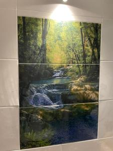 a painting of a river on a bathroom wall at Torii House in Estación El Salto