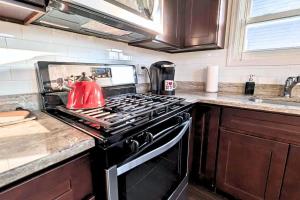 a kitchen with a stove with a tea kettle on it at Spacious 4BR 2BA - 7Min to EWR & 20-40Min to NYC - 2 FREE Parking Spaces in Oak Island Junction