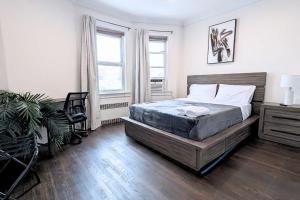 a bedroom with a bed and a desk and a chair at Spacious 4BR 2BA - 7Min to EWR & 20-40Min to NYC - 2 FREE Parking Spaces in Oak Island Junction