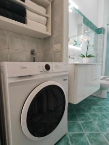Una lavadora y secadora blancas en un baño. en Arthome, en Milán