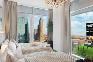 a bedroom with two beds and a large window at Luxury Apartments - Urban Oasis by Missoni - Business Bay - Canal View - 10 Minutes from Dubai Mall Burj Khalifa in Dubai +133 photos