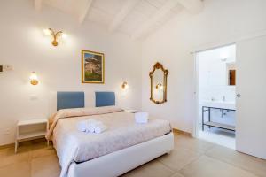 a bedroom with a large bed and a mirror at Agriturismo il Contadino in Otranto