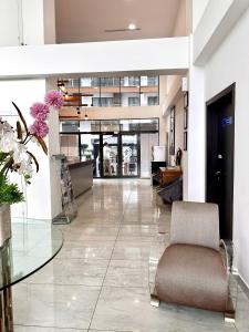 a lobby with a chair and a glass table at RDA 1bedroom at The Signature Apartment in Accra +13 photos