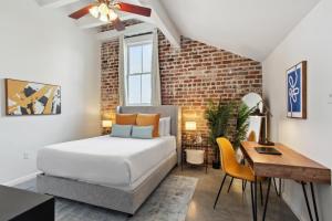 a bedroom with a bed and a desk at Warehouse District Lovely One Bedroom and Den in New Orleans