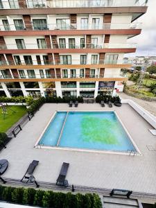 an empty swimming pool in front of a building at RDA 1bedroom at The Signature Apartment in Accra