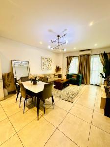 a living room with a table and a couch at RDA 1bedroom at The Signature Apartment in Accra