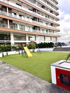 a playground in front of a large building at RDA 1bedroom at The Signature Apartment in Accra