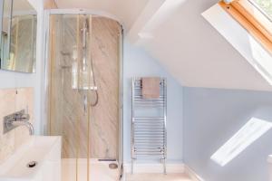 a bathroom with a shower and a sink at Call Out Cottage in Sledmere +43 photos