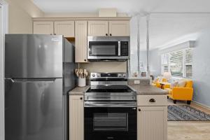 a kitchen with a stainless steel refrigerator and microwave at Bayshore Beach Beauty in Nokomis +26 photos