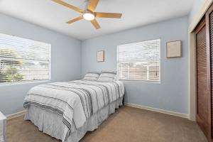 a bedroom with a bed and a ceiling fan at Bayshore Beach Beauty in Nokomis