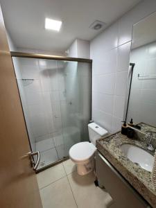 a bathroom with a shower and a toilet and a sink at FLAT MANAIRA APART HOTEl in João Pessoa