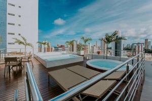 a balcony with a swimming pool on top of a building at FLAT MANAIRA APART HOTEl in João Pessoa