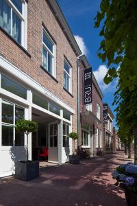 a brick building with a street in front of it at Hotel Bru in Bruinisse