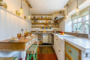 a kitchen with white cabinets and wooden counter tops at 2 Bed in Colkirk oc-j33005 in Colkirk