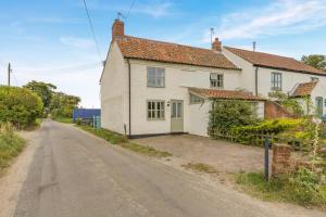 a white house on the side of a road at 2 Bed in Colkirk oc-j33005 in Colkirk