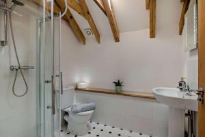 a bathroom with a shower and a toilet and a sink at Barley Barn in Kimberley +10 photos