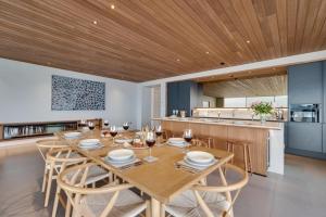 a dining room and kitchen with a wooden ceiling at Rock Cove in Cove +54 photos