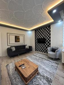 a living room with a couch and a coffee table at Poyraz suit in Bursa