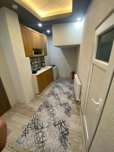a small kitchen with a door and a floor at Poyraz suit in Bursa