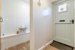 a bathroom with a shower and a sink at Valentine Cottage in Snape