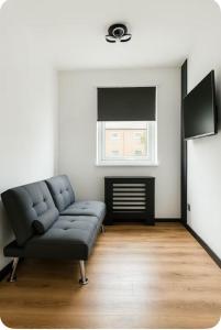 a living room with a couch and a window at Luxury sanctuary in Moortown