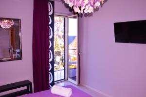 a room with a large glass door with a balcony at B&B A Due Passi Dal Mare in Taormina