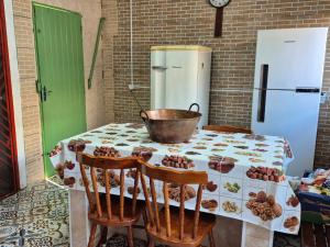 a kitchen with a table with a bucket on it at Summer House in Ubatuba in Ubatuba