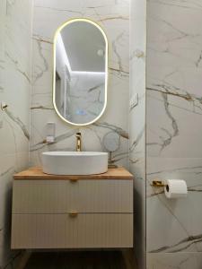 a bathroom with a sink and a mirror at myHome z widokiem na wodę in Piła +25 photos