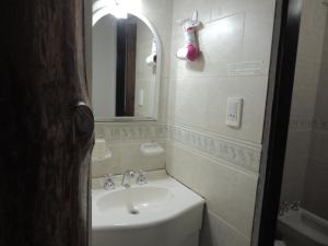 a white bathroom with a sink and a mirror at Cabañas La Brama in Aluminé +24 photos