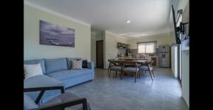 a living room with a blue couch and a table at Santa Cruz Suite #22 in La Paz