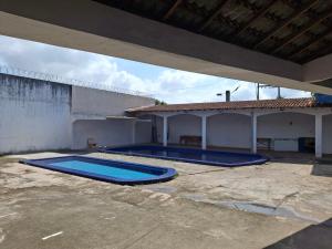 two swimming pools in the courtyard of a house at Aconchego benevides Barcelona in Benevides