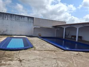 a swimming pool sitting next to a building at Aconchego benevides Barcelona in Benevides +19 photos