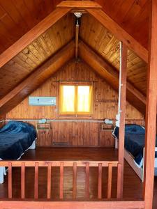 una habitación con dos camas en una cabaña de madera en Los olivillos, en Balneario Pehuén-Có 11 fotos más