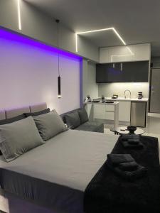 a living room with a large bed and a kitchen at Crystal Grey Elite Appartment 3 in Serres