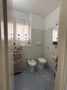 a white bathroom with a toilet and a sink at The Happy Place Montecatini in Montecatini Terme +24 photos
