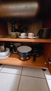 a shelf with pots and pans and other dishes at Departamento SAN LUIS CENTRO CON COCHERA in San Luis