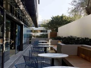 a row of tables and chairs in a courtyard at Tribe Perth Kings Park in Perth