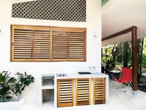 a house with a desk and a red chair at Villa Guaitil in Punta Uva +3 photos