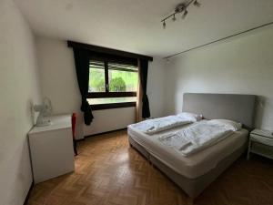 a bedroom with a white bed and a window at Beautiful apartment near Luzern, view to Rigi,Pilatus Mountain in Luzern