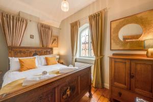 a bedroom with a large bed and a window at The Dutch House in Snettisham