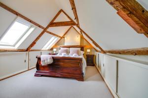 a bedroom with a bed in a room with windows at Willow Cottage in Wighton