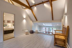 a large bedroom with a bed and a mirror at The Granary in Banningham